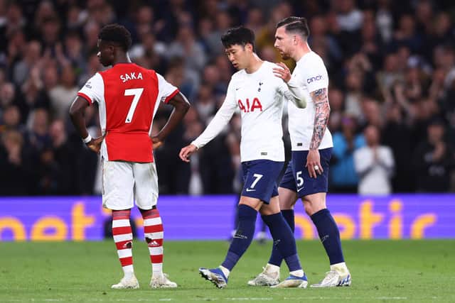 Heung-Min Son of Tottenham Hotspur is consoled by team mate Pierre-Emile Hojbjerg as he is substituted during the Premier League match between Tottenham Hotspur and Arsenal. (Photo by Clive Rose/Getty Images)