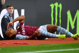 Ollie Watkins of Aston Villa reacts as he lies injured during the Premier League match (Photo by Dan Mullan/Getty Images)