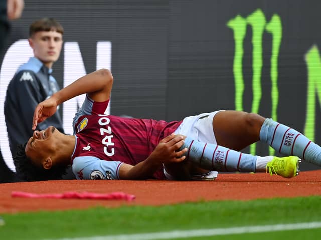 Ollie Watkins of Aston Villa reacts as he lies injured during the Premier League match (Photo by Dan Mullan/Getty Images)