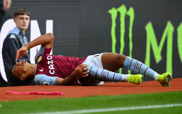 Ollie Watkins of Aston Villa reacts as he lies injured during the Premier League match (Photo by Dan Mullan/Getty Images)