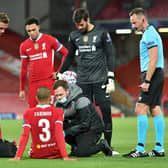 Fabinho of Liverpool is seen to by medical staff after sustaining an injury during the UEFA  (Photo by Peter Powell -