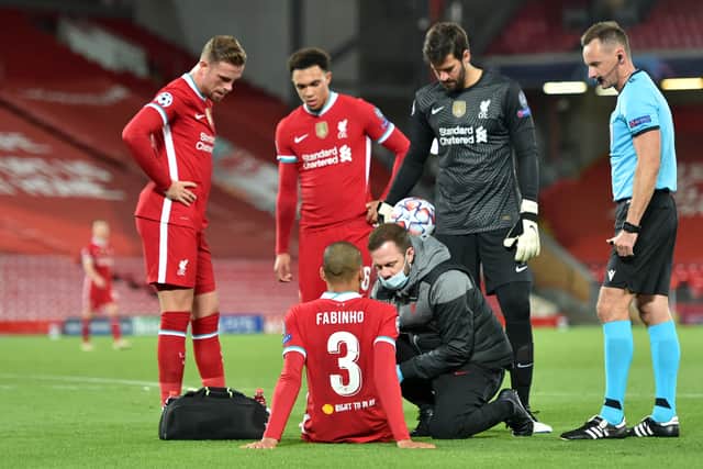 Fabinho of Liverpool is seen to by medical staff after sustaining an injury during the UEFA  (Photo by Peter Powell -