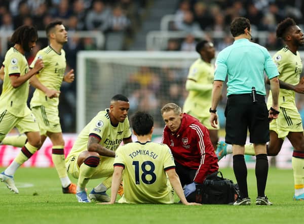 Takehiro Tomiyasu of Arsenal receives medical treatment during the Premier League match  (Photo by Ian MacNicol/Getty Images)