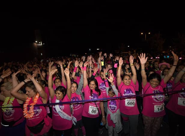 <p>Hundreds of people join together in their free pink t-shirts as they take part in last year’s Midnight Walk to raise money for St Luke’s Hospice (Credit: St Luke’s Hospice)</p>