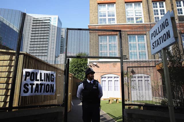 A police officer outside a polling station at the Tower Hamlets elections after Lutfur Rahman was convicted of electoral fraud. Credit: Dan Kitwood/Getty Images