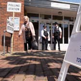 Police officers stand outside a polling station in Tower Hamlets in 2015 - the elections over which Lutfur Rahman was convicted of electoral fraud and removed from office. Credit: LEON NEAL/AFP via Getty Images