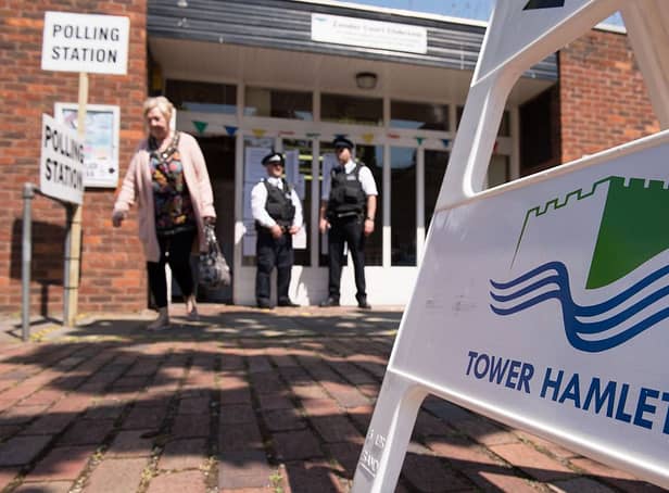 Police officers stand outside a polling station in Tower Hamlets in 2015 - the elections over which Lutfur Rahman was convicted of electoral fraud and removed from office. Credit: LEON NEAL/AFP via Getty Images