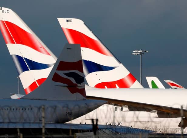 <p>British Airways planes at London Heathrow Airport terminal 5. Credit: ADRIAN DENNIS/AFP via Getty Images</p>
