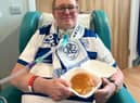 Steve Carr, a QPR fan with motor neurone disease, ready to eat his first bacon roll in months (Credit: NHS England) 