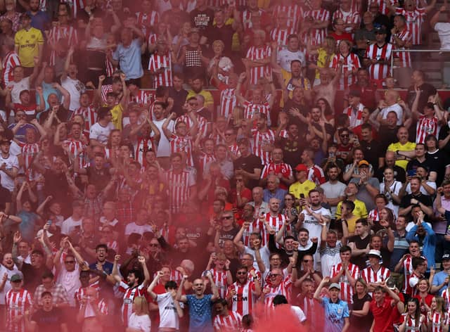 Brentford fans celebrate during the English Premier League football match (Photo by ADRIAN DENNIS/AFP via Getty Images)