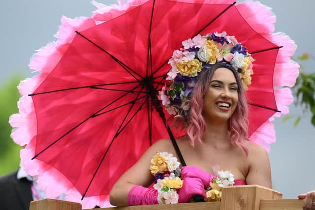 A visitor in a flower themed dress reacts as they attend the 2022 RHS Chelsea Flower Show in London. (Photo: Getty)