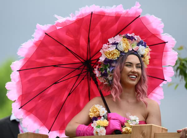 A visitor in a flower themed dress reacts as they attend the 2022 RHS Chelsea Flower Show in London. (Photo: Getty)
