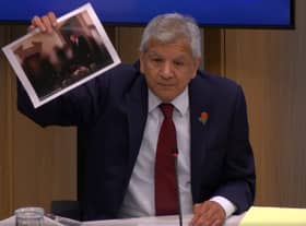 Unmesh Desai held up a photograph of the PM during a City Hall meeting: Photo: LW