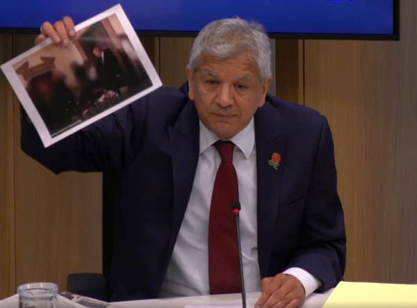 Unmesh Desai held up a photograph of the PM during a City Hall meeting: Photo: LW
