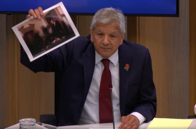 Unmesh Desai held up a photograph of the PM during a City Hall meeting: Photo: LW