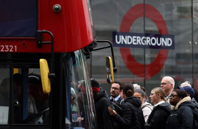 Commuters attempt to board a bus outside Victoria train station in London on June 6, 2022, during a 24-hour strike by nearly 4,000 London Underground station staff. (Photo by HOLLIE ADAMS/AFP via Getty Images)