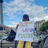 Protestor holding a Black Women Matter sign.