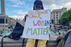 Protestor holding a Black Women Matter sign.