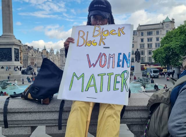 Protestor holding a Black Women Matter sign.