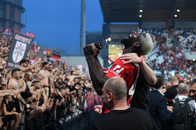 Tiemoue Bakayoko of AC Milan celebrates with the fans after their side finished the season  (Photo by Chris Ricco/Getty Images)