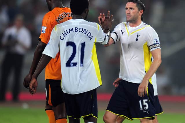Tottenham Hotspur (R) is congratulated by teammate Pascal Chimbonda (C) after scoring his second (Photo credit should read FREDERIC J. BROWN/AFP 