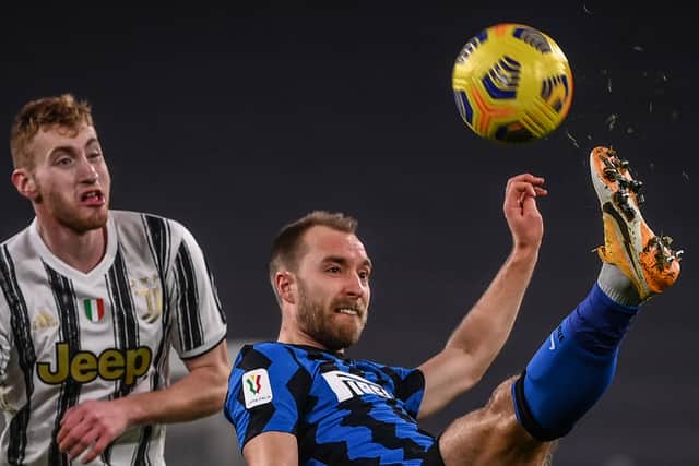 Christian Eriksen clears a ball under pressure from Juventus’ Swedish forward Dejan Kulusevski (L) d  (Photo by MARCO BERTORELLO/AFP via Getty Images)