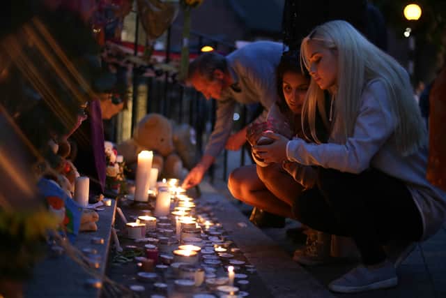 People light candles as they observe a vigil outside Notting hill Methodist Church following the blaze at Grenfell Tower. Photo: Getty