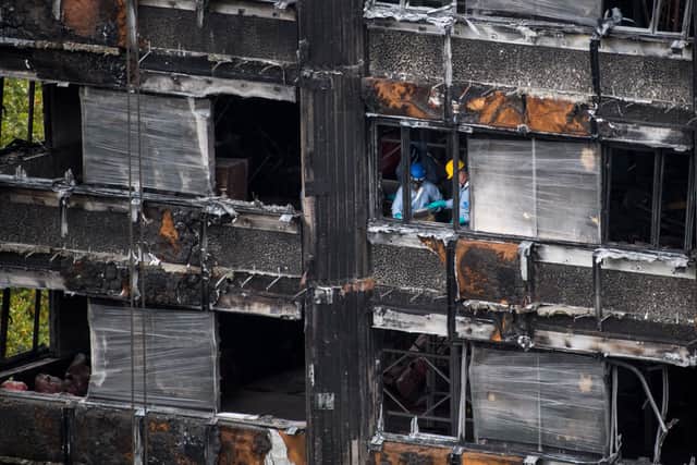 Police investigators are seen inside the burned out shell of Grenfell Tower in London. Photo: Getty