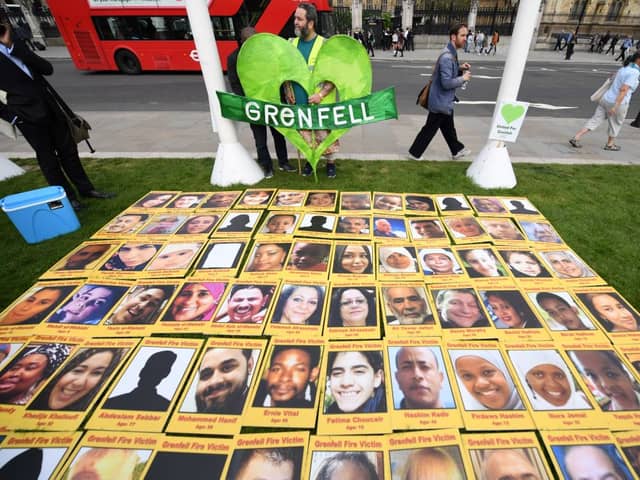 Photos of the victims of Grenfell Tower laid out. Credit: CHRIS J RATCLIFFE/AFP via Getty Images