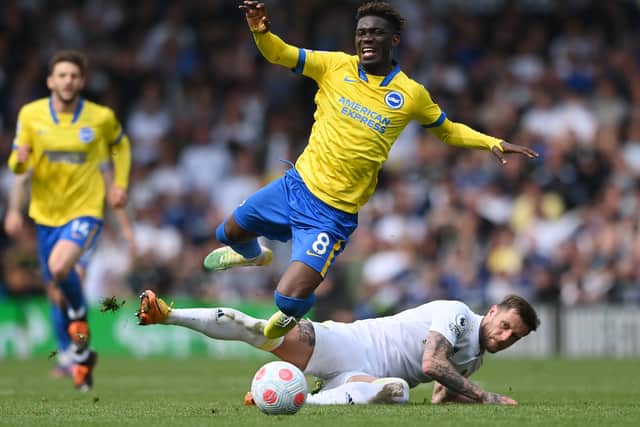 Yves Bissouma of Brighton & Hove Albion is fouled by Liam Cooper of Leeds United (Photo by Stu Forster/Getty Images)