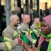 A group of firefighters, wearing Grenfell hero badges, formed a guard of honour opposite Ladbroke Grove Tube station in an emotional display of solidarity. Credit: Damondo Dar