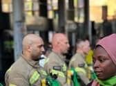 A group of firefighters, wearing Grenfell hero badges, formed a guard of honour opposite Ladbroke Grove Tube station in an emotional display of solidarity. Credit: Damondo Dar
