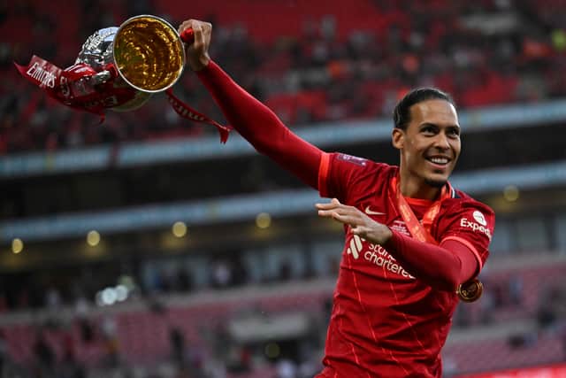 Dutch defender Virgil van Dijk celebrates with the trophy after winning the English FA Cup final (Photo by BEN STANSALL/AFP via Getty Images)