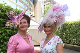 One racegoer has chosen a butterfly headpiece while her friend sports colourful feathers. Credit: Claudia Marquis