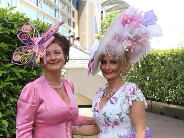 One racegoer has chosen a butterfly headpiece while her friend sports colourful feathers. Credit: Claudia Marquis