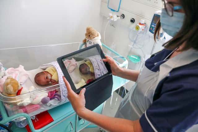 A nurse in the ICU unit with a newborn baby. Photo: Getty