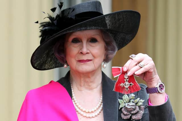 April Ashley holds her Member of the British Empire (MBE) medal. Image: Sean Dempsey - WPA Pool/Getty Images