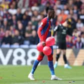 Wilfried Zaha of Crystal Palace carries balloons off the pitch during the Premier League match (Photo by Warren Little/Getty Images)
