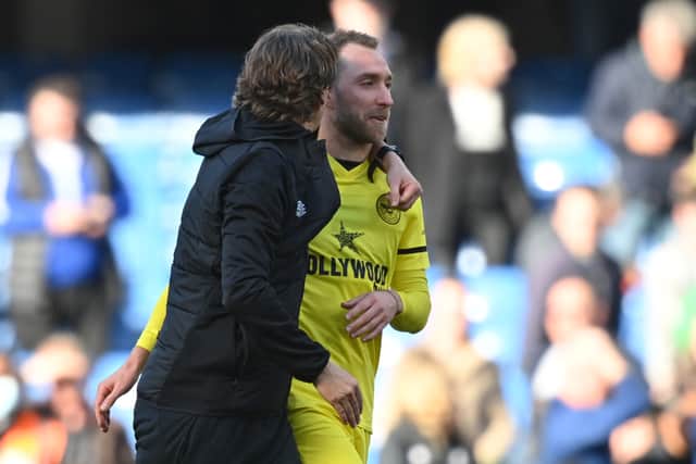 Danish midfielder Christian Eriksen (R) is congratulated by Brentford’s Danish head coach Thomas Frank (Photo by GLYN KIRK/AFP via Getty Images)