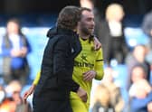Danish midfielder Christian Eriksen (R) is congratulated by Brentford’s Danish head coach Thomas Frank (Photo by GLYN KIRK/AFP via Getty Images)