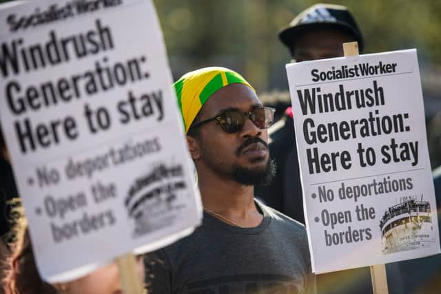 Demonstrators hold placards during a protest in support of the Windrush generation in Windrush Square, Brixton on April 20, 2018 in London, England (Photo by Chris J Ratcliffe/Getty Images)