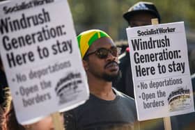 Demonstrators hold placards during a protest in support of the Windrush generation in Windrush Square, Brixton on April 20, 2018 in London, England (Photo by Chris J Ratcliffe/Getty Images)