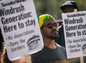 Demonstrators hold placards during a protest in support of the Windrush generation in Windrush Square, Brixton on April 20, 2018 in London, England (Photo by Chris J Ratcliffe/Getty Images)