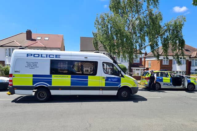 Police at the scene in Barnet, where a woman and her five-year-old son were stabbed to death. Photo: SWNS