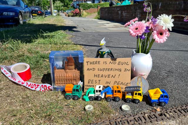 Tributes left at the scene in Brookside South, Barnet, to a woman and her five-year-old son who were stabbed to death. Photo: SWNS