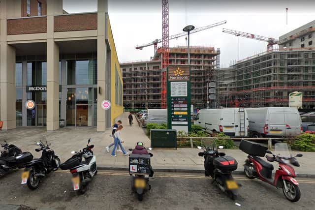 Delivery drivers wait in front of the Canning Town McDonald’s, on the left, where the woman was sexually assaulted, with the Morrisons car park on the right, where the attacker fled to. Credit: Google