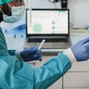 A doctor performing a nasal swab test on a patient in a medical clinic for a possible coronavirus infection. Photo: Adobe Stock