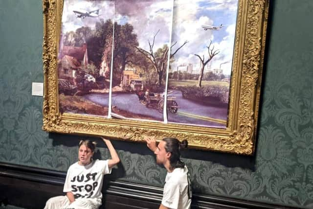 Activists Hannah Hunt and Eben Lazarus glued themselves to John Constable’s the Hay Wain at the National Gallery