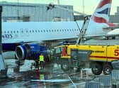 Dramatic scenes show firefighters tackling a fire on a British Airways passenger plane on Wednesday. Photo: SWNS