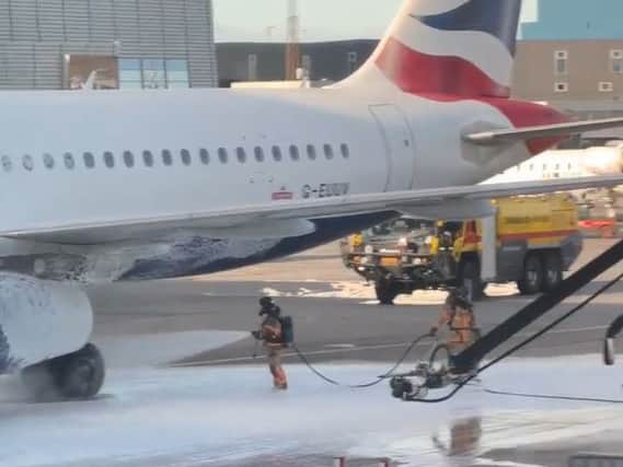 Dramatic scenes show firefighters tackling a fire on a British Airways passenger plane on Wednesday. Photo: SWNS